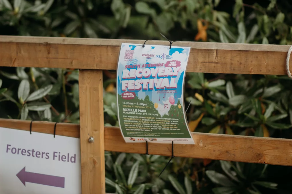recovery festival poster tied to a fence